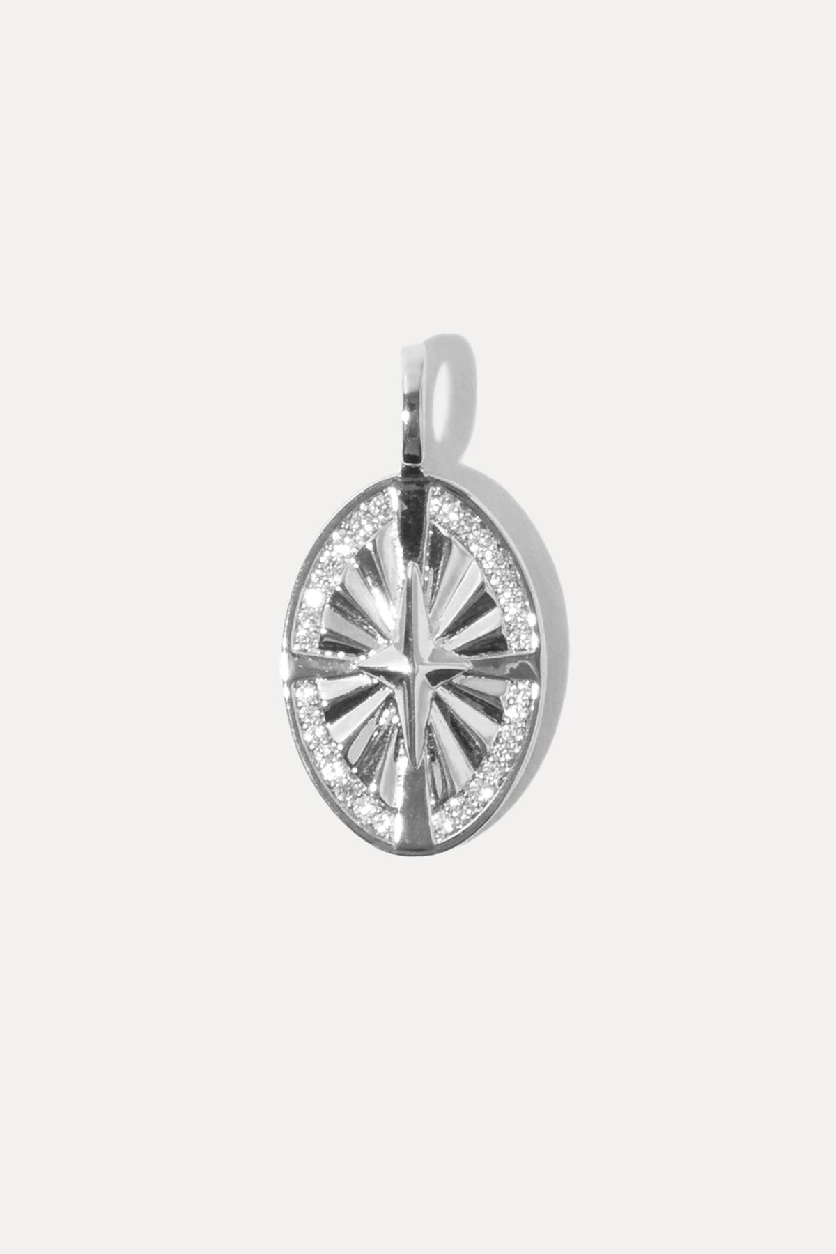 Silver starburst charm with a central sparkling stone set on a standard bail against a plain white background.