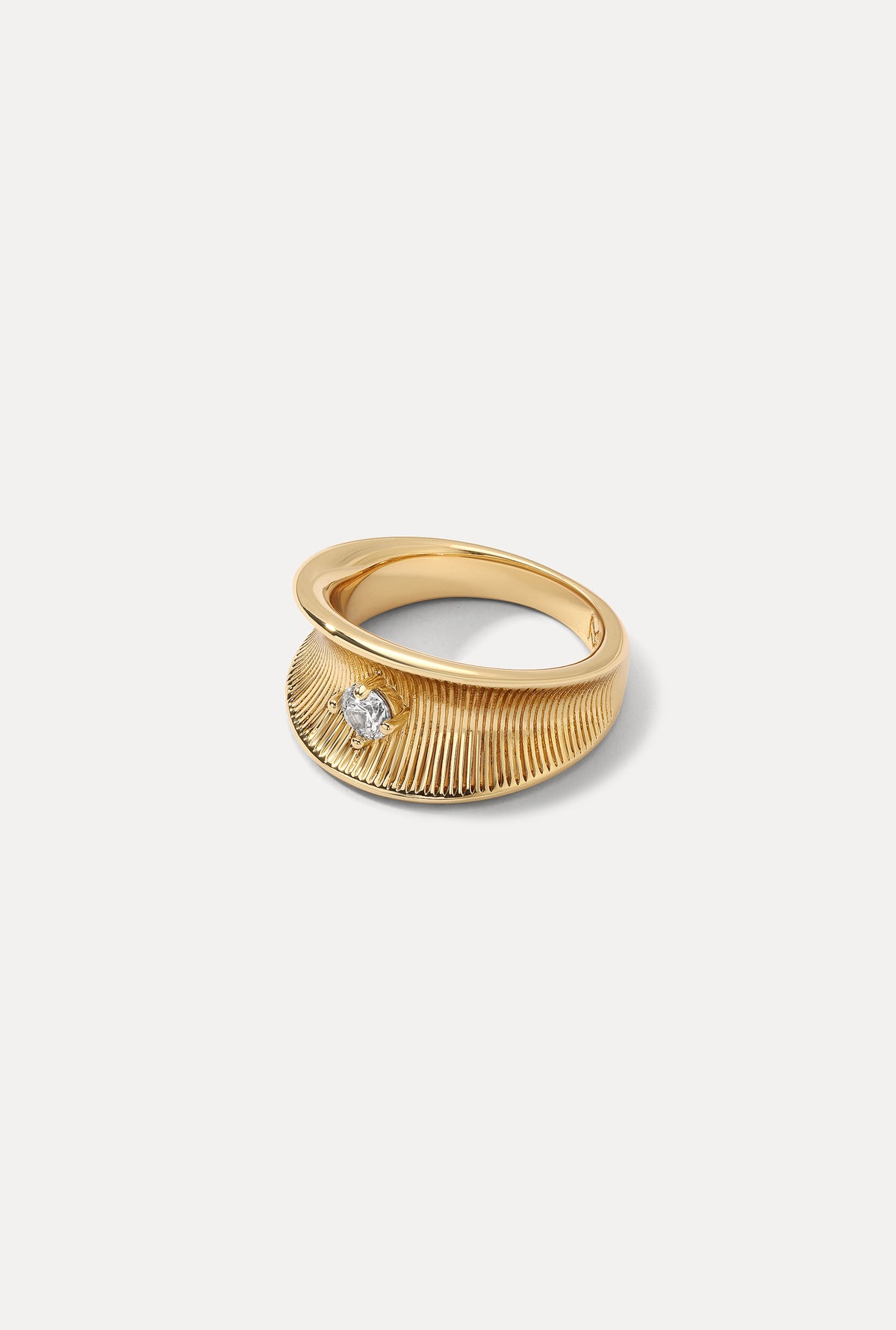 Gold Anne Marie ring featuring a tapered ribbed design with a sparkling CZ accent on a white backdrop.