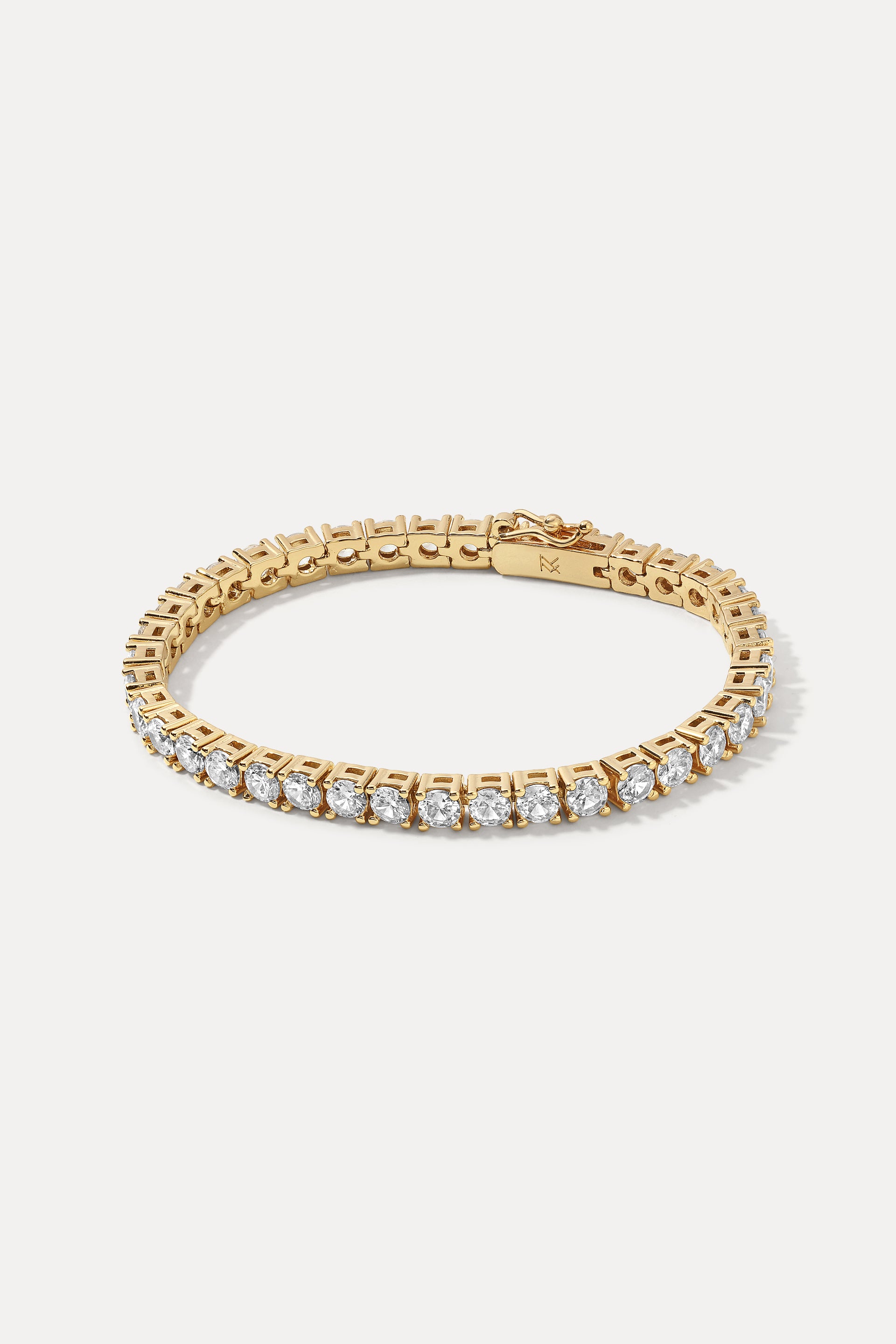 Gold Audrey Bracelet displayed in an oval loop on a white background, highlighting its tennis chain.
