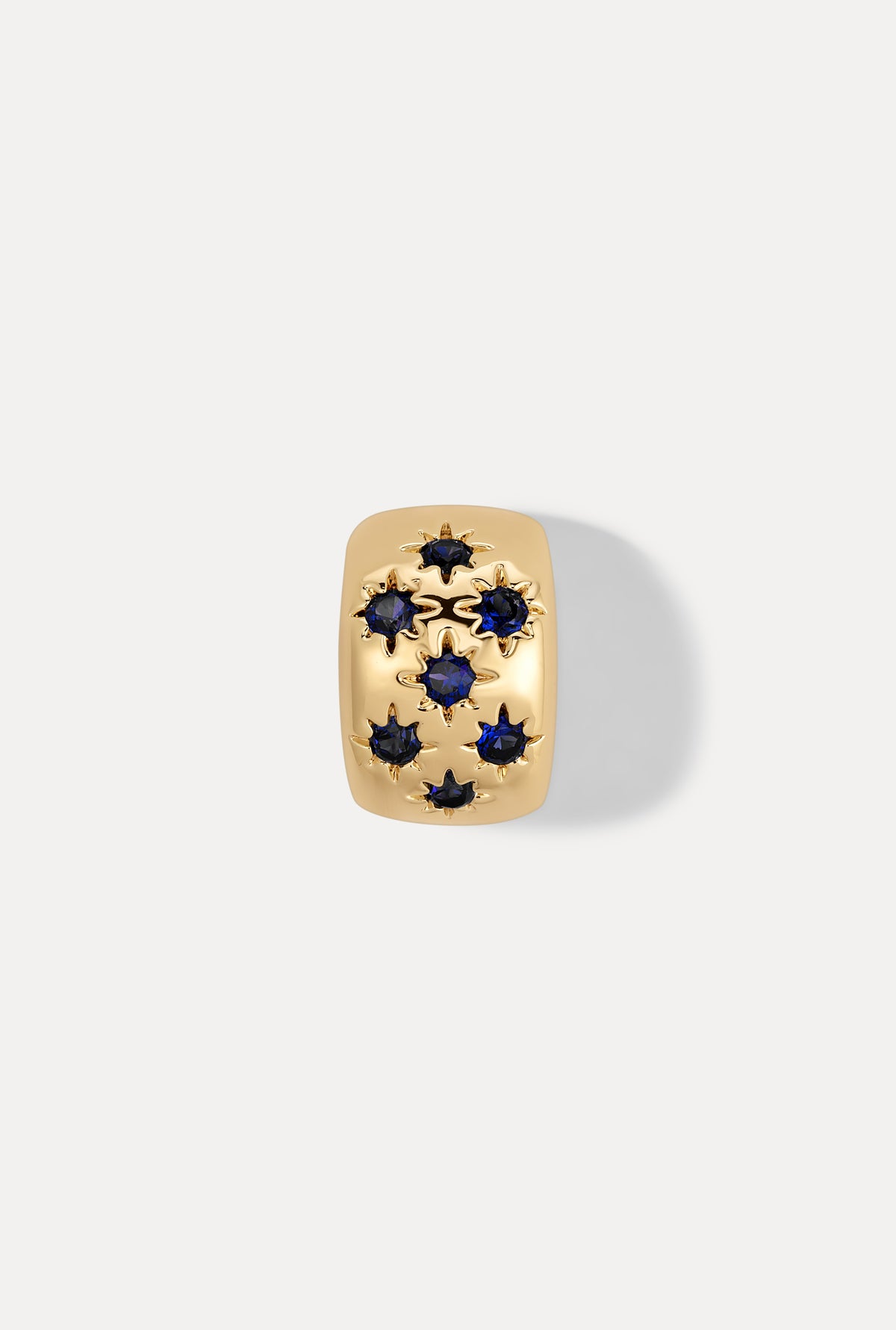 Gold Celeste slider charm with sparkling sapphire stones on white background