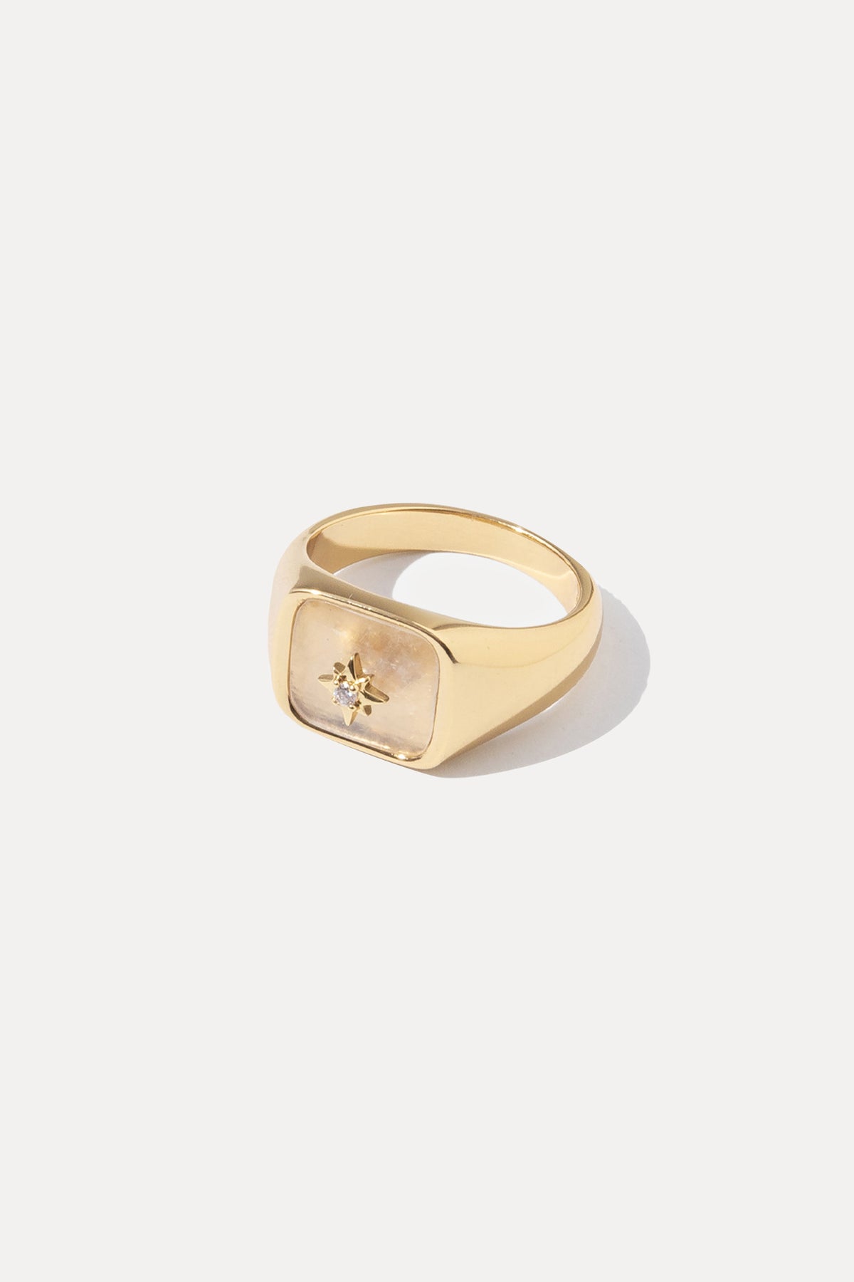 Gold Moonstone signet ring featuring an iridescent gemstone, centered on a plain white background.