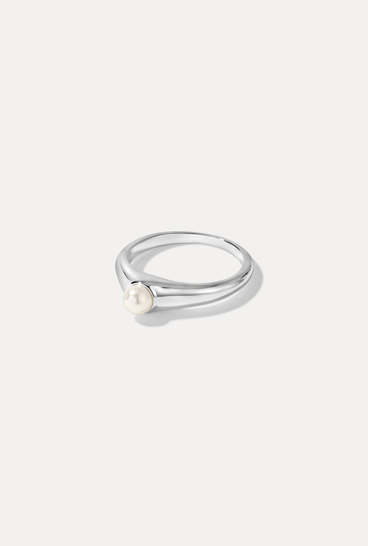 Silver Greta ring featuring a polished band and a natural pearl centerpiece on a white background.