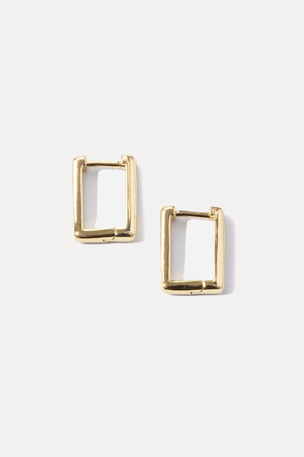 Pair of gold rectangular Kate Huggies displayed on a clean white background.