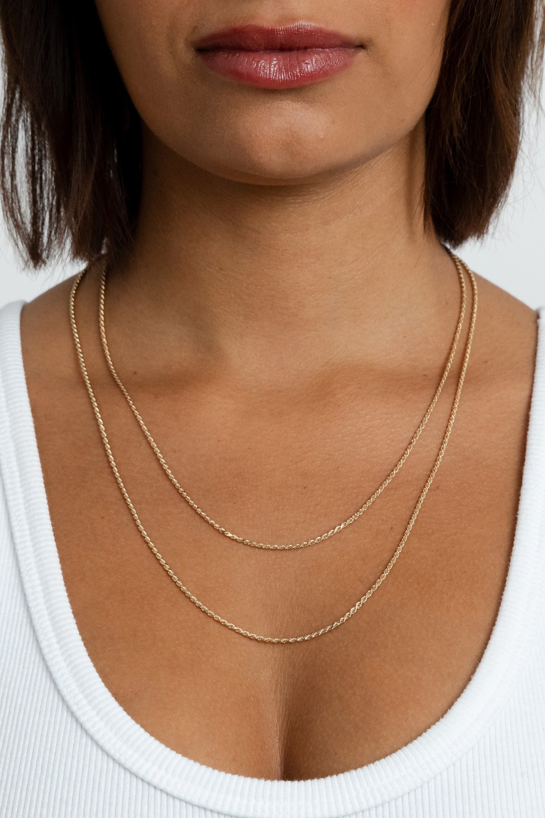Model wearing the gold Kate chain in two distinct lengths around her neck.
