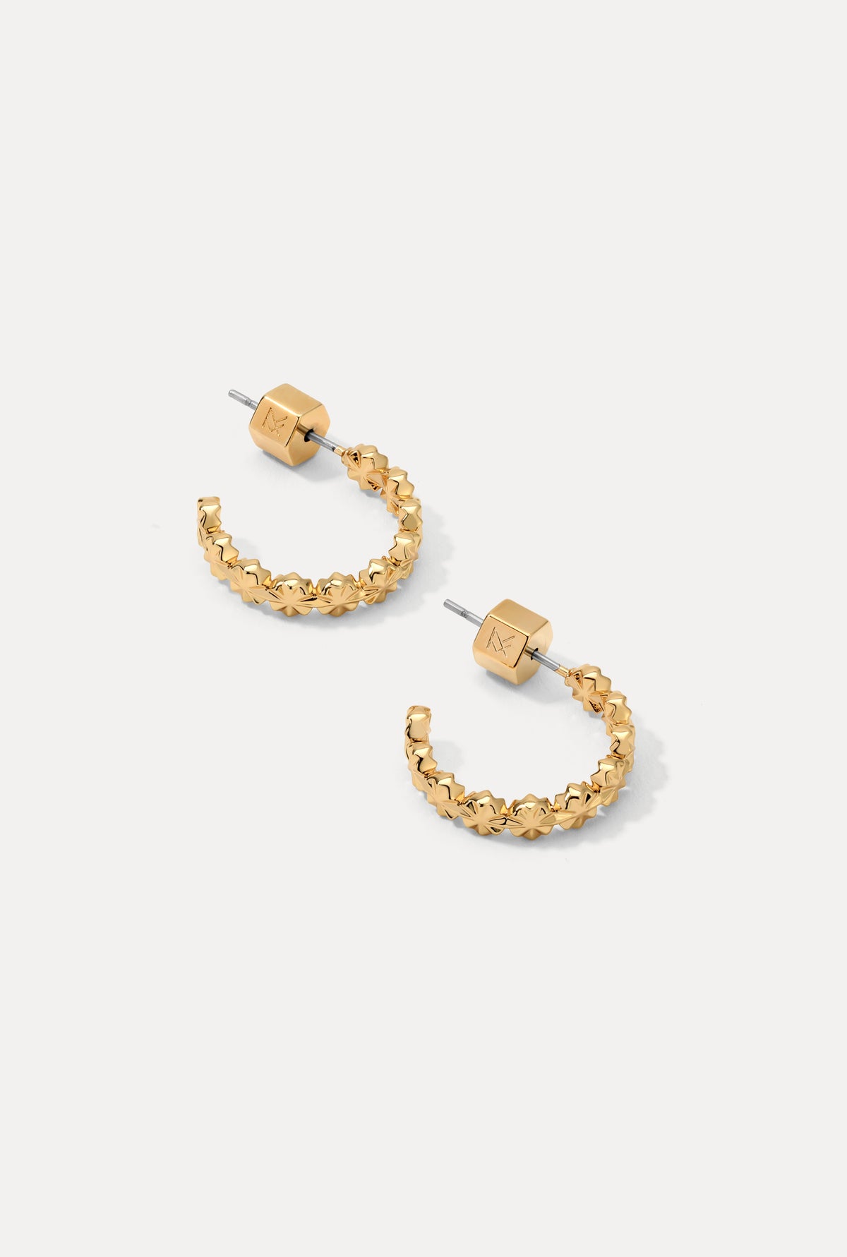 Pair of gold Lauren Hoops with starburst-inspired pattern on a clean white background.