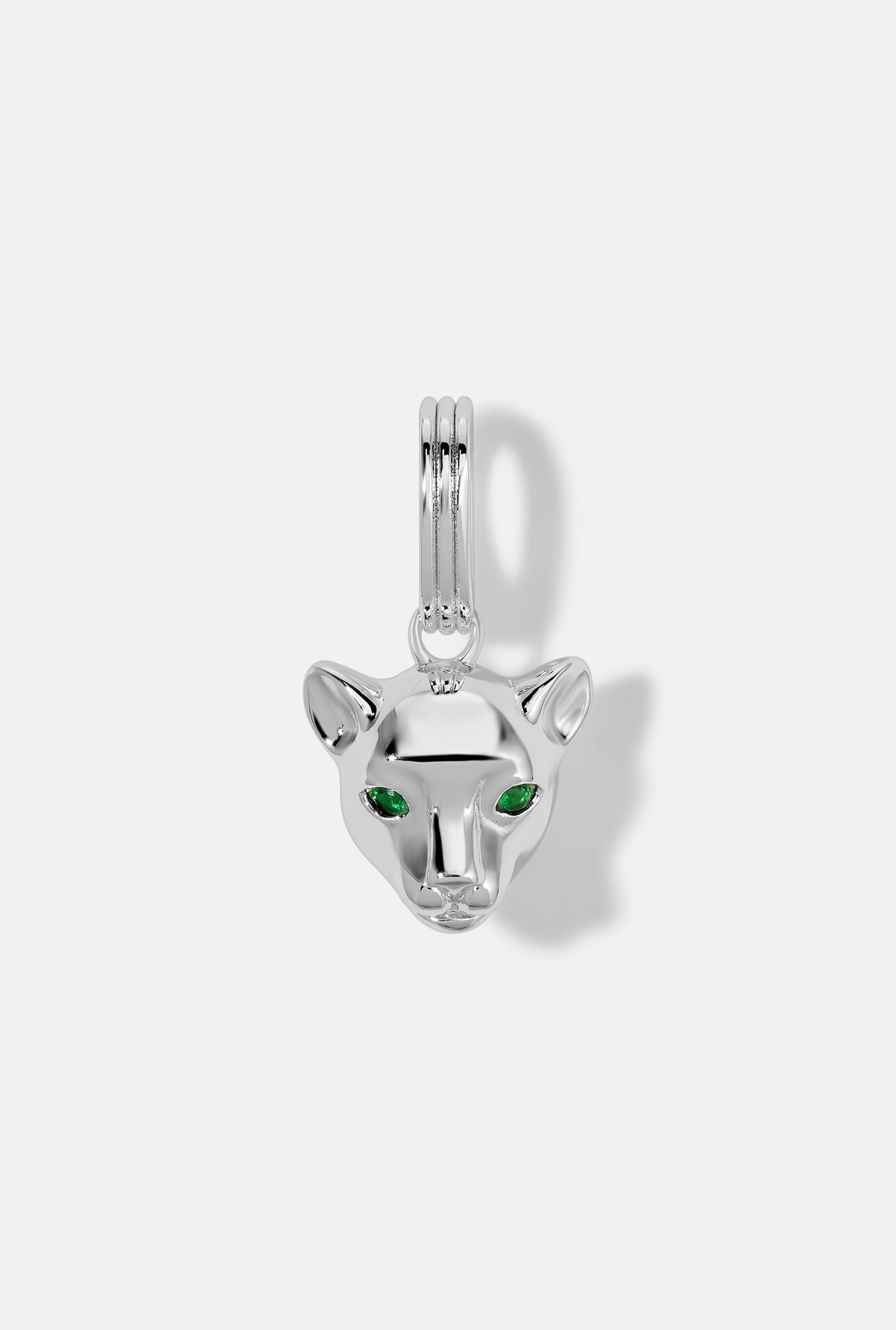 Silver panther charm with sparkling green emerald eyes on white background