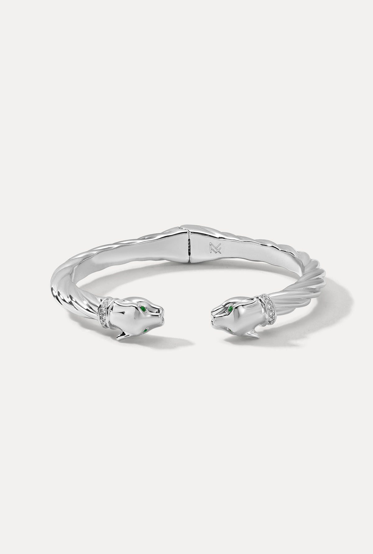 Silver Panther Cuff with a twisted cable band, panther heads, emerald eyes, and pavé CZ collars on a white background