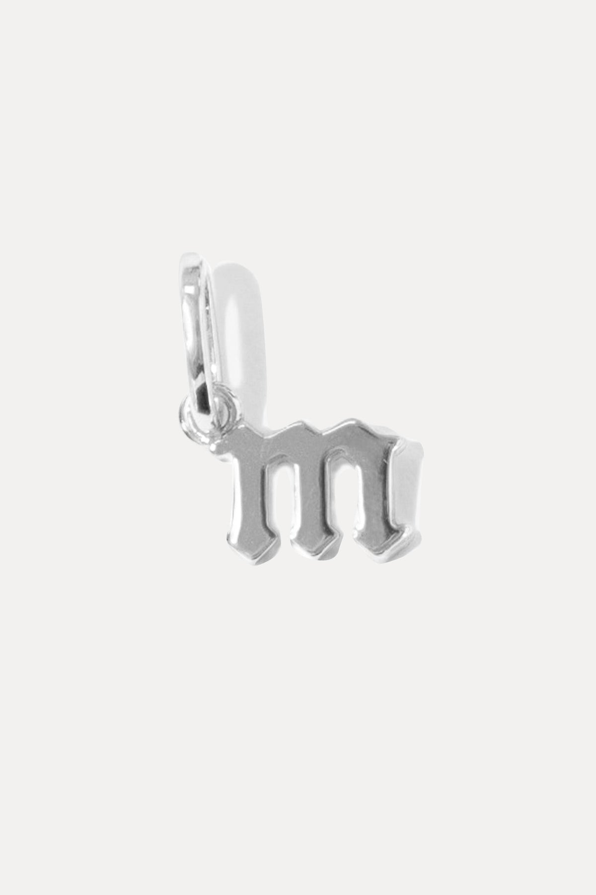Petite silver gothic initial charm in the letter "m" on a bail against a plain white background.