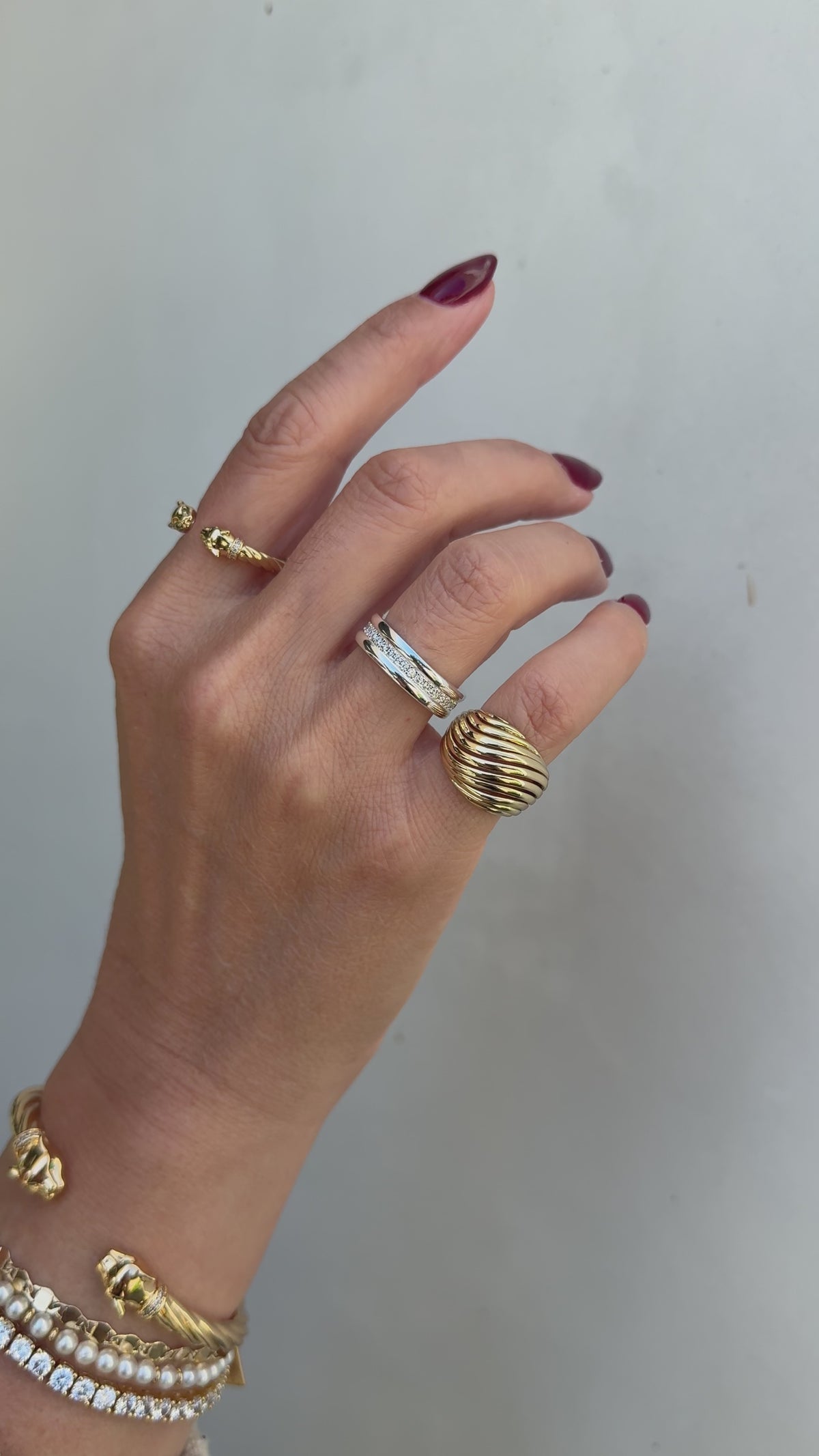 Model image of the Etta and Panther rings in gold paired with the silver Ariana ring. 