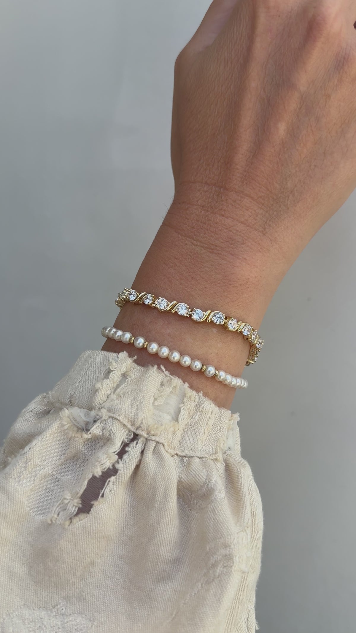 Video of a model's wrist wearing the beautiful Delilah bracelet and Bette bracelet in gold. 