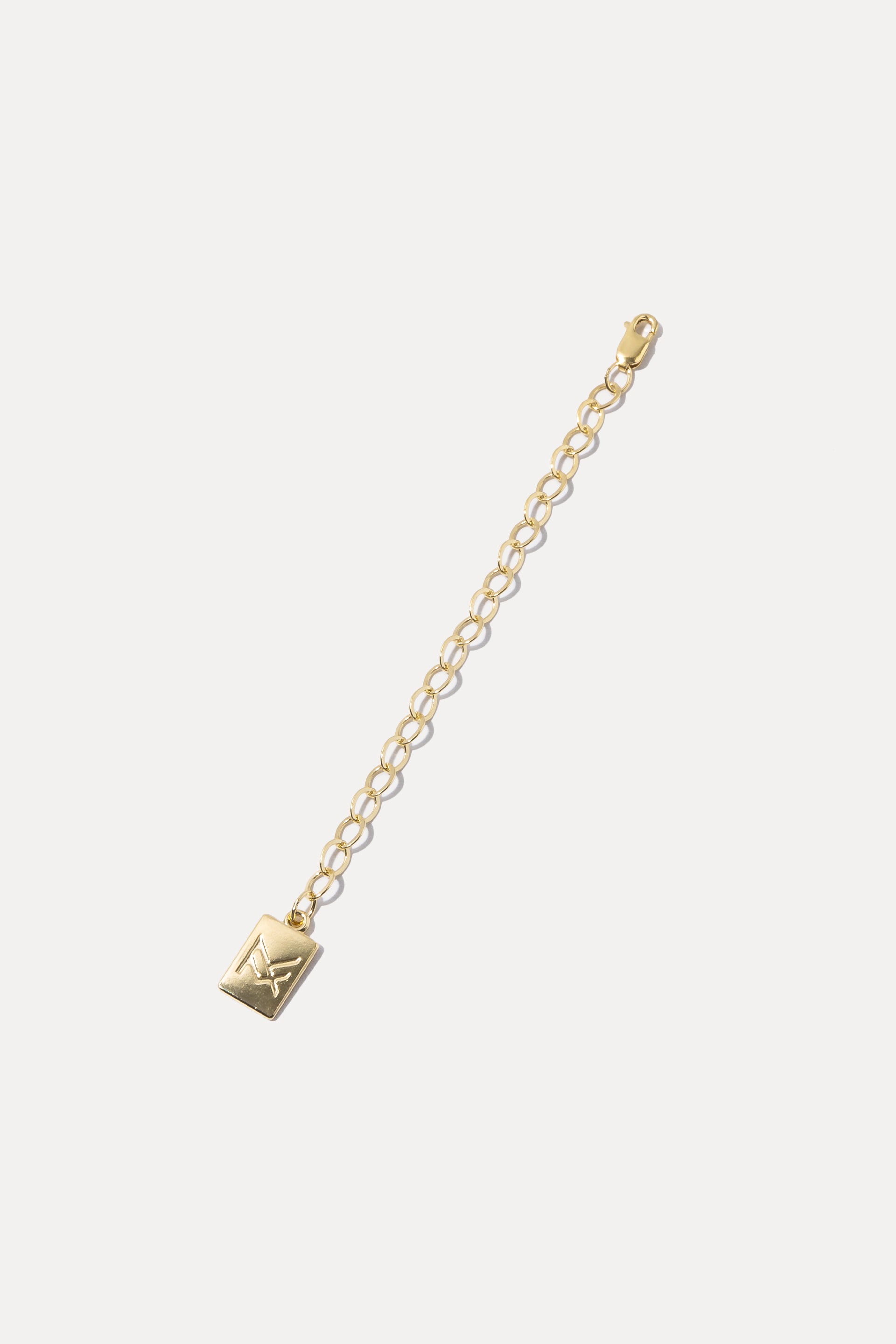 Gold filled necklace extender chain with logo charm tag, displayed on a clean white background.